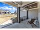 Relaxing covered porch with a comfortable wooden chair, offering a view of the neighborhood and the sky at 3240 Donlin Dr, Wake Forest, NC 27587