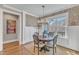 Dining area with natural light, stylish chandelier, and views of the outdoor landscape at 3240 Donlin Dr, Wake Forest, NC 27587