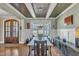 Elegant dining room featuring wainscoting, a decorative ceiling, and abundant natural light from a large window at 3240 Donlin Dr, Wake Forest, NC 27587