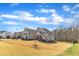 Expansive exterior view of a home with beautiful architectural details set against a clear blue sky and a large lawn at 3240 Donlin Dr, Wake Forest, NC 27587