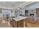 Open-concept kitchen featuring a large island with seating, stainless steel appliances, and hardwood flooring at 3240 Donlin Dr, Wake Forest, NC 27587