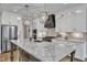 Beautiful kitchen featuring white cabinets, stainless steel appliances, and a large center island with a marble countertop at 3240 Donlin Dr, Wake Forest, NC 27587