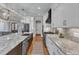 Open kitchen with granite counters, island with sink, and stainless steel appliances at 3240 Donlin Dr, Wake Forest, NC 27587