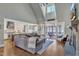Open-concept living room with a high ceiling, seamlessly connected to the kitchen and a screened porch at 3240 Donlin Dr, Wake Forest, NC 27587