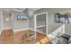 Bright living room featuring hardwood floors, a glass table, and a TV with a home image at 3240 Donlin Dr, Wake Forest, NC 27587