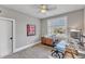 Office space featuring a modern glass desk, natural light, and carpet flooring at 3240 Donlin Dr, Wake Forest, NC 27587