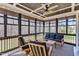 Relaxing screened porch features a ceiling fan, cozy seating and natural light at 3240 Donlin Dr, Wake Forest, NC 27587