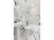 Modern bathroom featuring a pedestal sink, black fixtures, and a tub with stylish marble-like tile surround at 3541 Rugby Rd, Durham, NC 27707