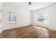 Bright bedroom with hardwood floors, crown molding, and large windows offering ample natural light at 3541 Rugby Rd, Durham, NC 27707