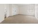 Bright bedroom featuring neutral carpet, white walls, closet, and a window letting in natural light at 3541 Rugby Rd, Durham, NC 27707