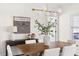 Dining room with modern light fixture, wood table, six chairs, and decorative art at 3541 Rugby Rd, Durham, NC 27707