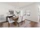 Dining room with modern light fixture, wood table, six chairs, and large window at 3541 Rugby Rd, Durham, NC 27707