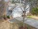 Aerial view of a two-story gray house featuring a two-car garage at 3541 Rugby Rd, Durham, NC 27707