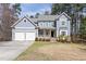 Charming two-story home with a well-manicured lawn, attached two car garage, and inviting front porch at 3541 Rugby Rd, Durham, NC 27707