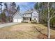Traditional two-story home with an attached two-car garage, porch, and manicured lawn, nestled among mature trees at 3541 Rugby Rd, Durham, NC 27707