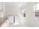 Well-lit laundry room equipped with a washer, dryer, white cabinets and multiple bright windows at 3541 Rugby Rd, Durham, NC 27707