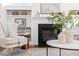 Cozy living room with an elegant fireplace and bookshelves at 3541 Rugby Rd, Durham, NC 27707