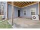 Covered patio with grey siding, exposed rafters, and an air conditioning unit at 3541 Rugby Rd, Durham, NC 27707