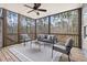 Screened patio features ceiling fan, outdoor furniture, and wooded views at 3541 Rugby Rd, Durham, NC 27707