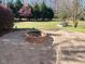 Inviting backyard with a brick fire pit area, ideal for outdoor entertaining and relaxation at 3709 Valley Pine Ct, Wendell, NC 27591