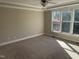 This spacious bedroom features carpet flooring, a ceiling fan, and natural light at 3709 Valley Pine Ct, Wendell, NC 27591
