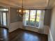 Elegant dining room features a decorative chandelier, detailed trim work, and a large window offering lots of natural light at 3709 Valley Pine Ct, Wendell, NC 27591