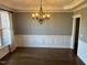 Dining room with chandelier and paneled walls at 3709 Valley Pine Ct, Wendell, NC 27591