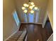 Foyer featuring hardwood floors, elegant chandelier, and a staircase leading to the upper level of the home at 3709 Valley Pine Ct, Wendell, NC 27591