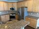 Kitchen features stainless steel appliances and granite countertops at 3709 Valley Pine Ct, Wendell, NC 27591