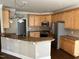 Kitchen features stainless steel appliances and a breakfast bar at 3709 Valley Pine Ct, Wendell, NC 27591