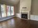 Bright living room boasts hardwood floors, a fireplace, and large windows for lots of natural light and a cozy ambiance at 3709 Valley Pine Ct, Wendell, NC 27591