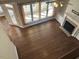 Open-concept living room with hardwood floors, a fireplace, and large windows that fill the space with natural light at 3709 Valley Pine Ct, Wendell, NC 27591