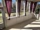 This porch is bright and open, featuring curtains for added shade and privacy at 3709 Valley Pine Ct, Wendell, NC 27591