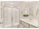 Elegant bathroom featuring a glass-enclosed shower, white marble countertop, and decorative plants and artwork at 385 Dasu Dr, Clayton, NC 27520