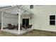 Cozy backyard patio featuring a pergola, swing, and outdoor furniture, perfect for relaxing and entertaining at 49 W Copenhaver Dr, Clayton, NC 27527