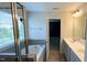 Bathroom features a glass shower, garden tub, double vanity, and large framed mirror at 49 W Copenhaver Dr, Clayton, NC 27527