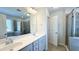 Bathroom features a double vanity, framed mirror, glass shower, and garden tub at 49 W Copenhaver Dr, Clayton, NC 27527