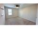 Cozy bedroom with plush carpet, natural light from the window, and open shelves at 49 W Copenhaver Dr, Clayton, NC 27527