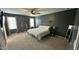 Spacious bedroom featuring two large windows, a ceiling fan, and carpeted flooring at 49 W Copenhaver Dr, Clayton, NC 27527
