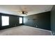 Bedroom featuring carpet, ceiling fan, and two windows providing natural light at 49 W Copenhaver Dr, Clayton, NC 27527