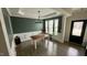 Bright dining room with modern chandelier, accent wall, wainscoting, and ample natural light at 49 W Copenhaver Dr, Clayton, NC 27527