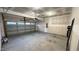 Spacious two-car garage with ample storage space and a rolling metal garage door at 49 W Copenhaver Dr, Clayton, NC 27527