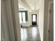 Inviting hallway featuring wood flooring, neutral walls, and seamless flow to the dining area at 49 W Copenhaver Dr, Clayton, NC 27527