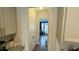 Clean and well-lit hallway with white walls and a view into the dining area at 49 W Copenhaver Dr, Clayton, NC 27527