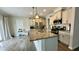Spacious kitchen featuring a large center island with a sink, stainless steel appliances, and white cabinetry at 49 W Copenhaver Dr, Clayton, NC 27527