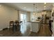 Open concept kitchen featuring an island with seating and view to the breakfast nook and backyard at 49 W Copenhaver Dr, Clayton, NC 27527