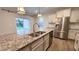Gourmet kitchen featuring stainless steel appliances, a granite island and pendant lighting at 49 W Copenhaver Dr, Clayton, NC 27527