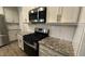 Kitchen features modern stainless steel appliances, granite countertops, and white cabinets at 49 W Copenhaver Dr, Clayton, NC 27527