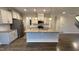 Gourmet kitchen features an island, stainless appliances, granite countertops, and ample storage space at 49 W Copenhaver Dr, Clayton, NC 27527