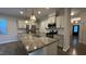 Bright kitchen featuring stainless steel appliances, granite counters, gas range, and breakfast bar seating at 49 W Copenhaver Dr, Clayton, NC 27527